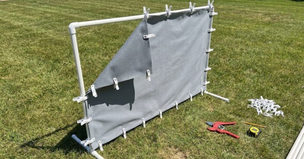 Stop Wasting Money on Inflatable Junk: The Grumpy Guide to an Outdoor Movie Night Setup DIY That Actually Works 3 Building a DIY outdoor movie screen using PVC pipe and blackout cloth.