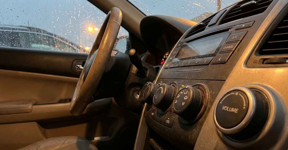 Close-up of tactile car dashboard knobs and buttons in an older vehicle